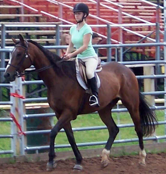 Sarah riding Strider at a horse show